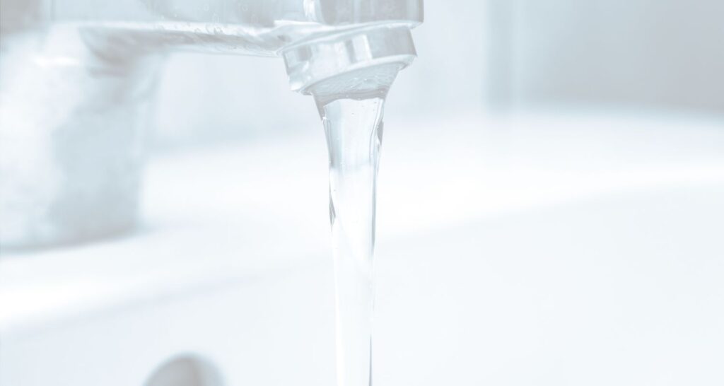 Background image of water coming from a faucet